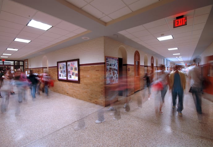 Students in motion in a school hallway.